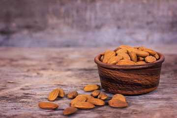 Almond. Almonds in a bowl on the old wooden background.
