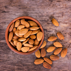 Almond. Almonds in a bowl on the old wooden background.