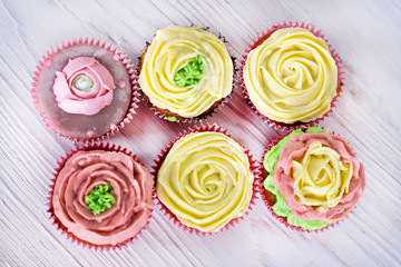 Tasty cupcakes on bright background