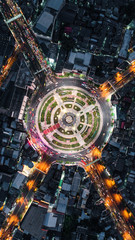 Road roundabout with car lots Wongwian Yai in Bangkok,Thailand. street large beautiful downtown at night light.  Aerial view , Top view ,cityscape ,Rush hour traffic jam