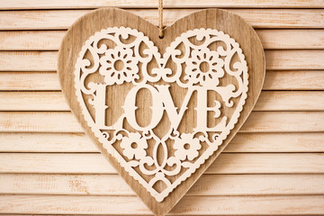 Heart hanging on wooden texture background