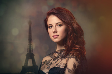 beautiful young woman standing in front of wonderful eiffel tower background