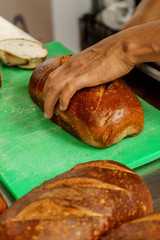 Freshly baked bread to be cut into a restaurant kitchen. - 139347496