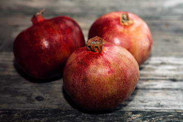 Fototapeta na wymiar Red pomegranate on wooden table
