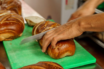Freshly baked bread to be cut into a restaurant kitchen. - 139347637
