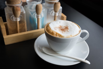 Cappuccino coffee cup with foam on black background