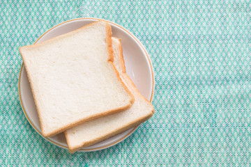 Sliced bread in plate on table.