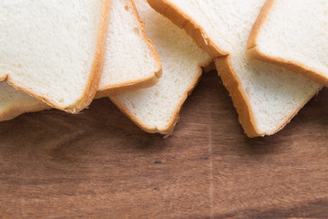 Sliced bread on wooden background.
