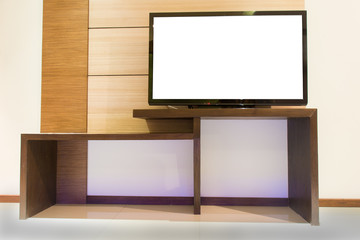 Light wooden TV cabinet with blank white TV in room interior.