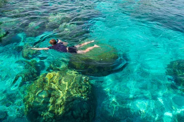 Printed roller blinds Diving Young man snorkeling over coral reef in transparent tropical sea, Rok island, Thailand.