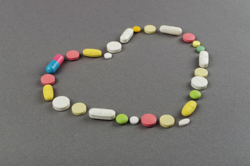 Heart created from colored pills. Medical concept