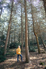 Fototapeta premium stylish hipster woman with backpack looking at amazing woods and mountains in summer, travel concept, space for text