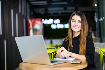 Happy smiling woman working with laptop in modern smart space hub