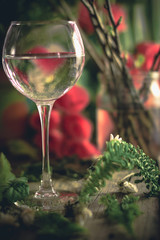 A glass of water on the flowers and plants against