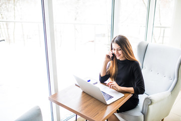 Young beautiful businesswoman sitting at desk, working at smart hub space.
