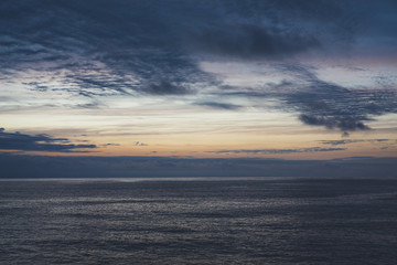 Clouds sky and sunlight sunset on horizon ocean. Silhouette person on background seascape dramatic atmosphere rays sunrise. Relax view waves sea, mockup nature evening perspective sunrise