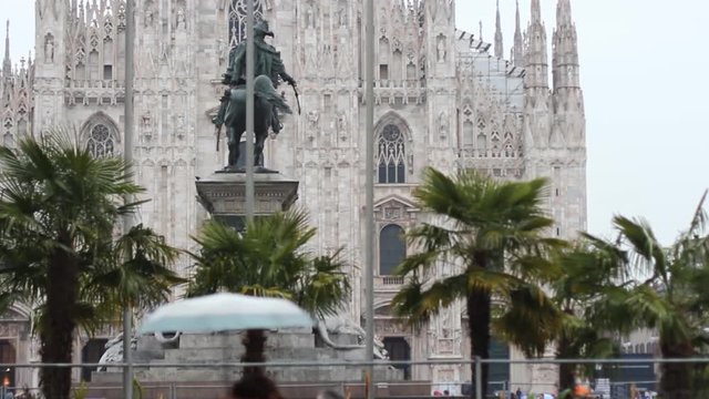 milan duomo with palm and vittorio emanuele II statue