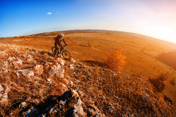 Cyclist Riding the Bike on the Mountain Rocky Trail at Sunset. Extreme Sports