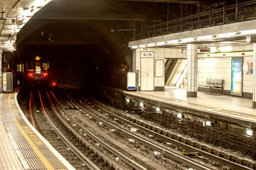 Subway train approaching in the station, London.