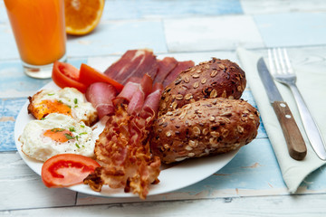 Freshly made breakfast with bacon,eggs and buns