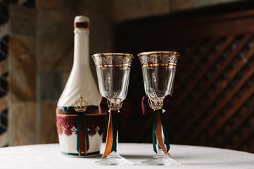 Luxury wedding decorated champagne bottle and glasses in the royal style