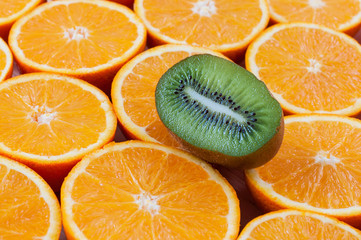 Kiwi and oranges background close-up