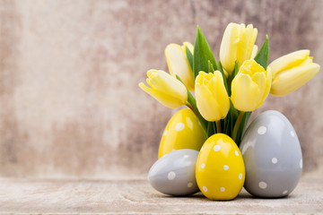 Spring decor, yellow tulips with easter eggs.