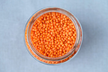 Red lentils in a glass. View from above.
