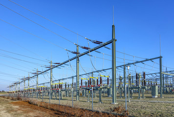 hight voltage tower in rural landscape with blue sky