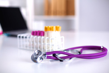 stethoscope near medical tubes on white background