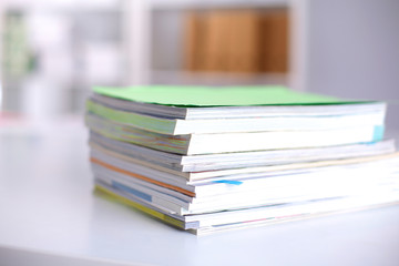 close up of stack of papers on white background