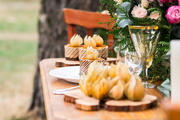 able decoration with flowers, food in a pine forest
