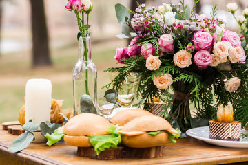 able decoration with flowers, food in a pine forest