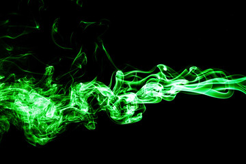 Green colored smoke on a black background.