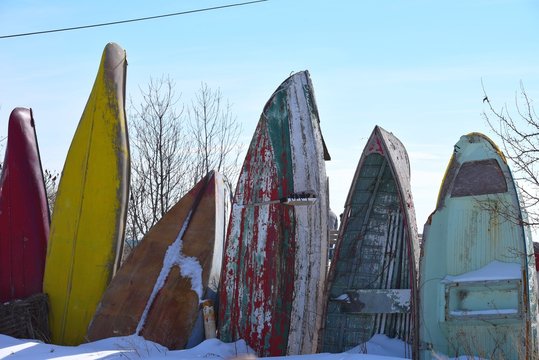 Vintage Well Worn Row Boats In Winter Scene