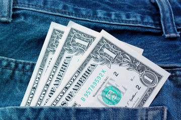 Dollars in the back pocket of jeans