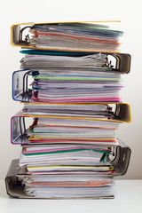 Seven folders with documents stacked in pile on the table