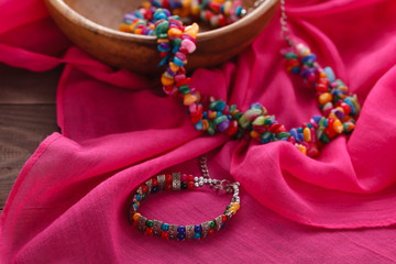 ethnic gem bijouterie lay on pink silk shawl