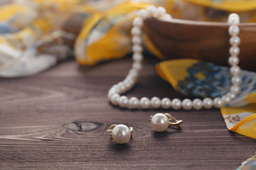 Pearl bijouterie lay on wooden table