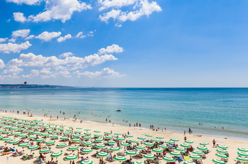 The Black Sea shore, blue clear water, beach with sand, umbrellas and sunbeds. Albena, Bulgaria