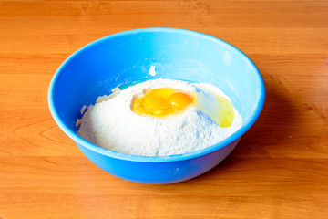 Eggs in flour. Preparation for baking. Detail of the egg yolk. Raw materials for the production of dough.