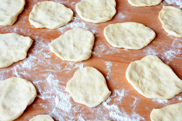 Czech baked buns with jam and sugar. Baking cakes. Traditional Czech recipe for buns. Festive delicacies. Buns on a baking pan.