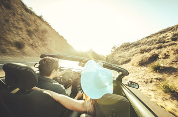 Couple driving on a convertible car