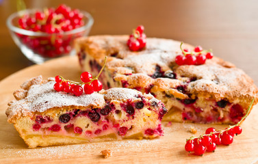 Piece of berry pie and red currants