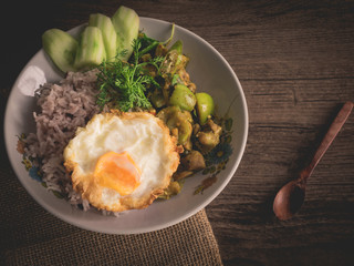 Vintage style Thai - Indian traditional food chicken green curry hot chili spicy with omelette on wooden background