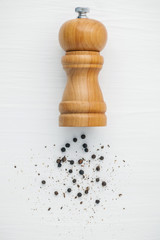 Closeup black pepper in wooden spoon on shabby teak wood table. Seasoning and species ingredients concept . Composition of black pepper for culinary ingredients.