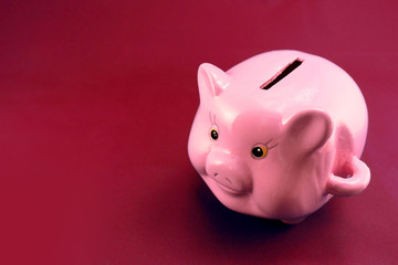 Piggy bank on a red background