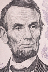 Vertical portrait of Abraham Lincoln's face on the US 5 dollar bill. Macro shot