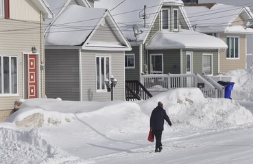 Woman walking in snowy road