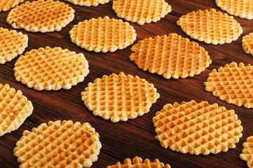 A lot of round belgian wafers on wooden background